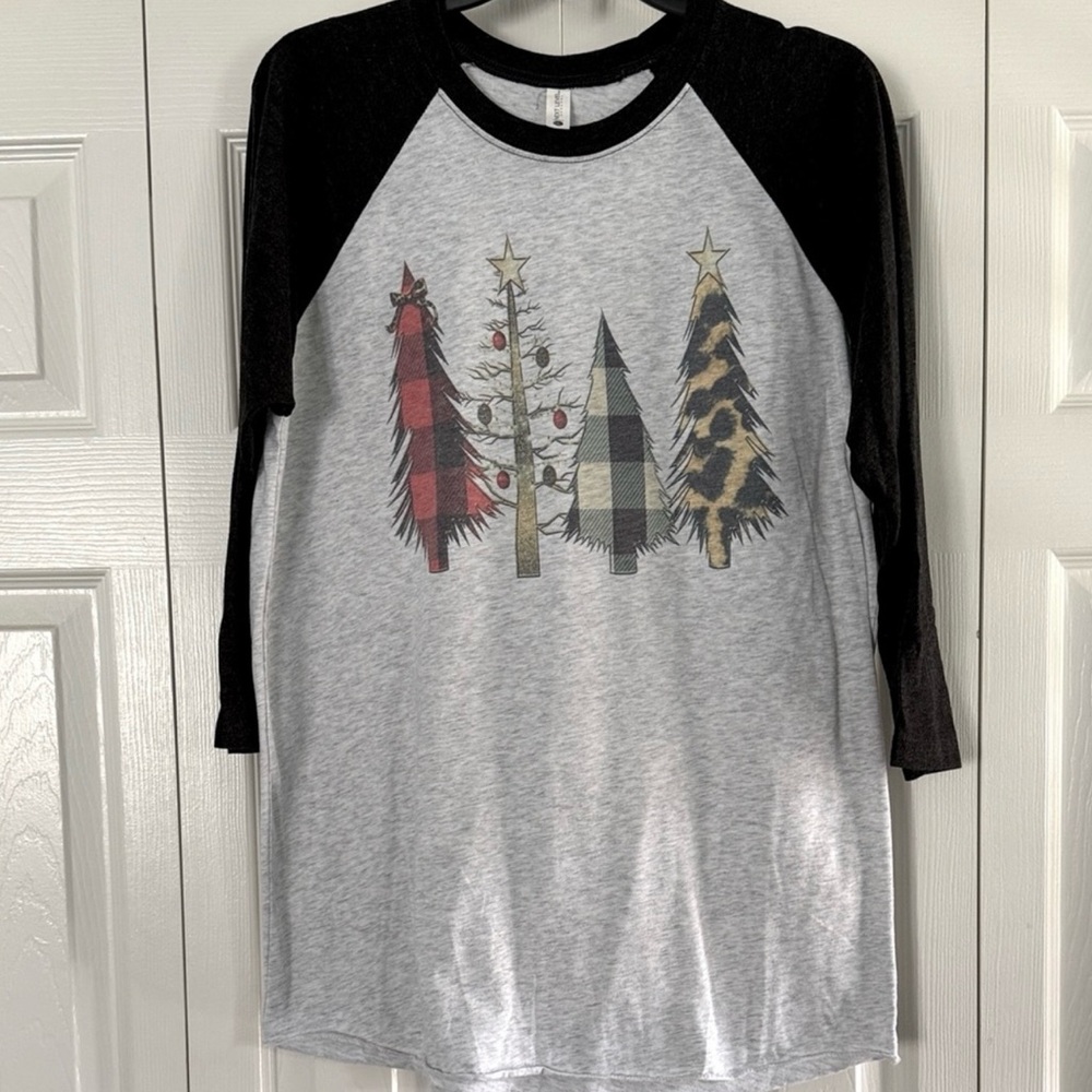 4 Christmas shirts. 1 large and 3 medium.